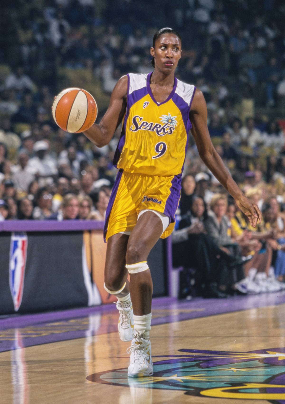 Lisa Leslie dribbles down the court.