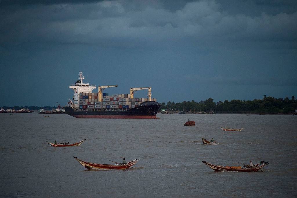 a container ship is anchored along the Yangon river