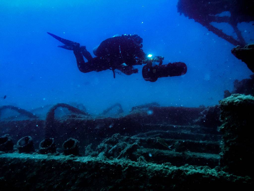 a scuba diver near a shipwreck