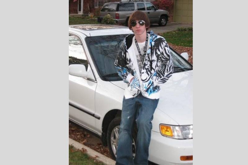 skaterboy poses with car