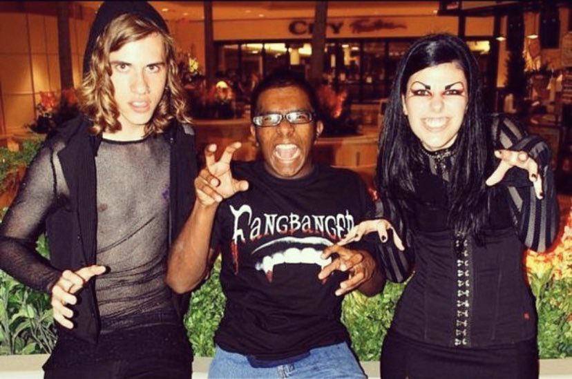 hot topic store manager poses with two kids