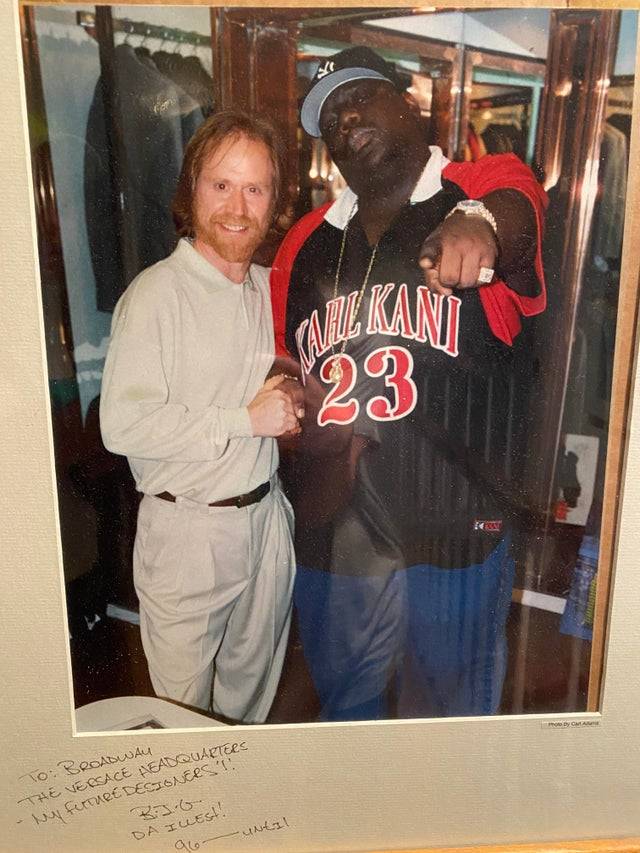 man standing next to notorious BIG