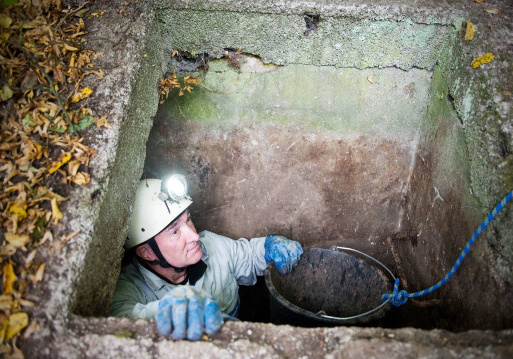 a  treasure hunter standing in a shaft