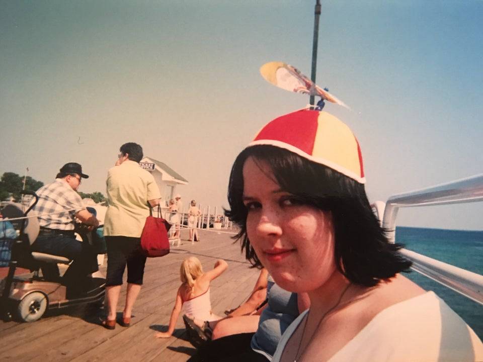 woman wearing propeller hat at the pier