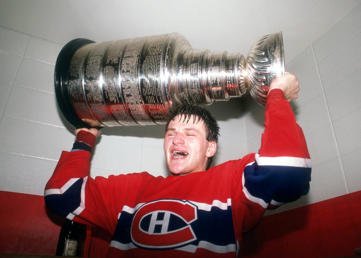 Claude Lemieux holds up the Stanley Cup.