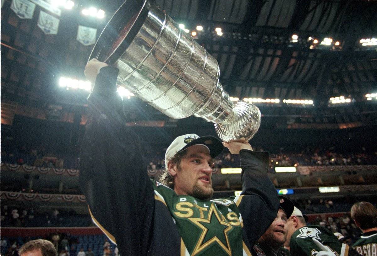 Derian Hatcher holes up the Stanley Cup.