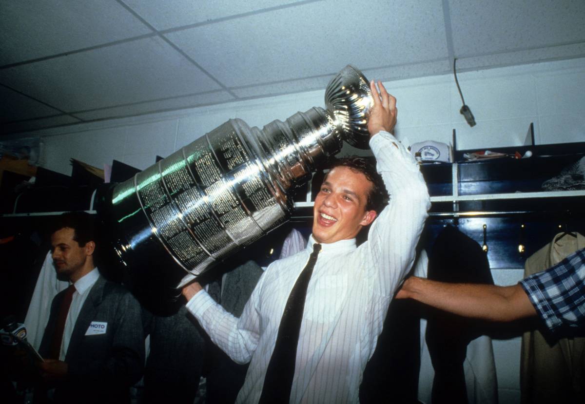 Kelly Buchberger holds the Stanley Cup in their Edmonton Oilers' locker room after defeating the Philadelphia Flyers.