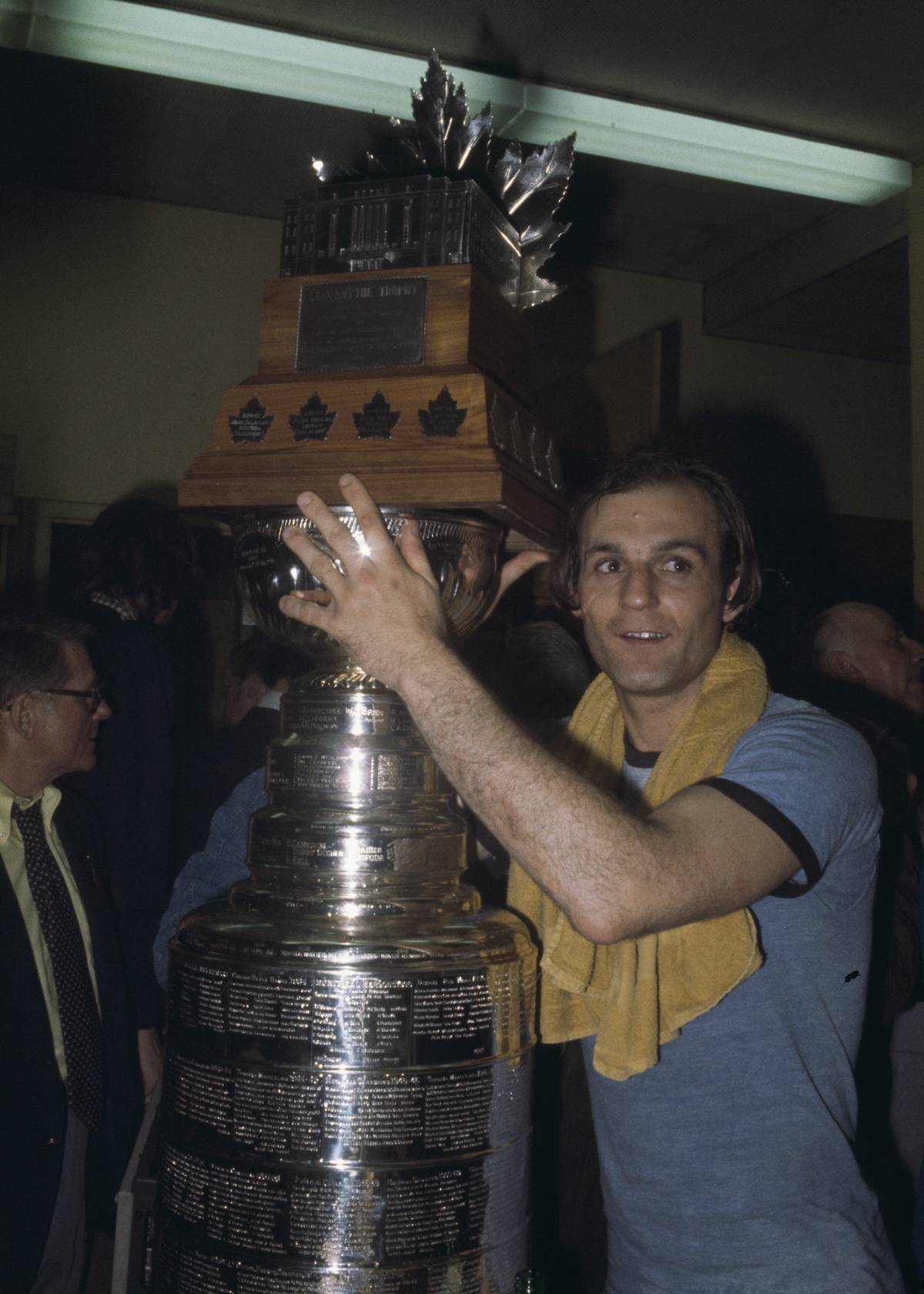 Guy Lafleur poses for a photo with the Stanley Cup Trophy and the Conn Smythe Trophy.