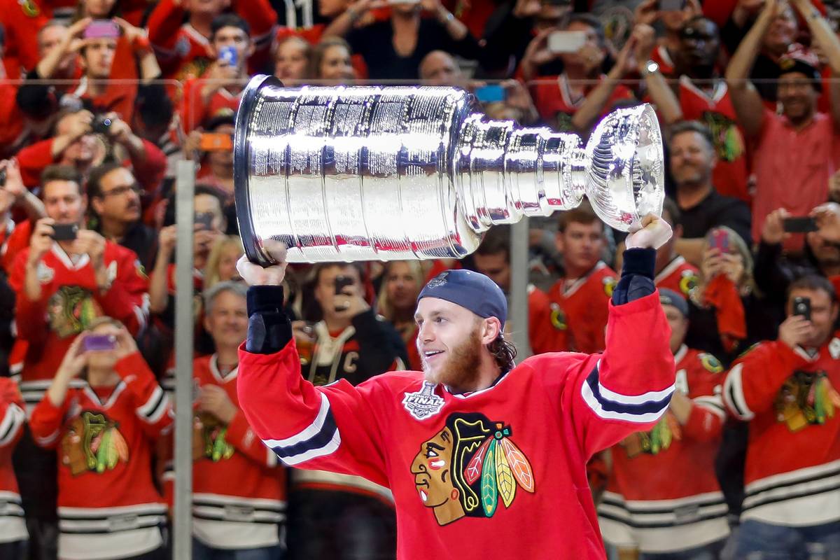 Patrick Kane holds up the Stanley Cup.