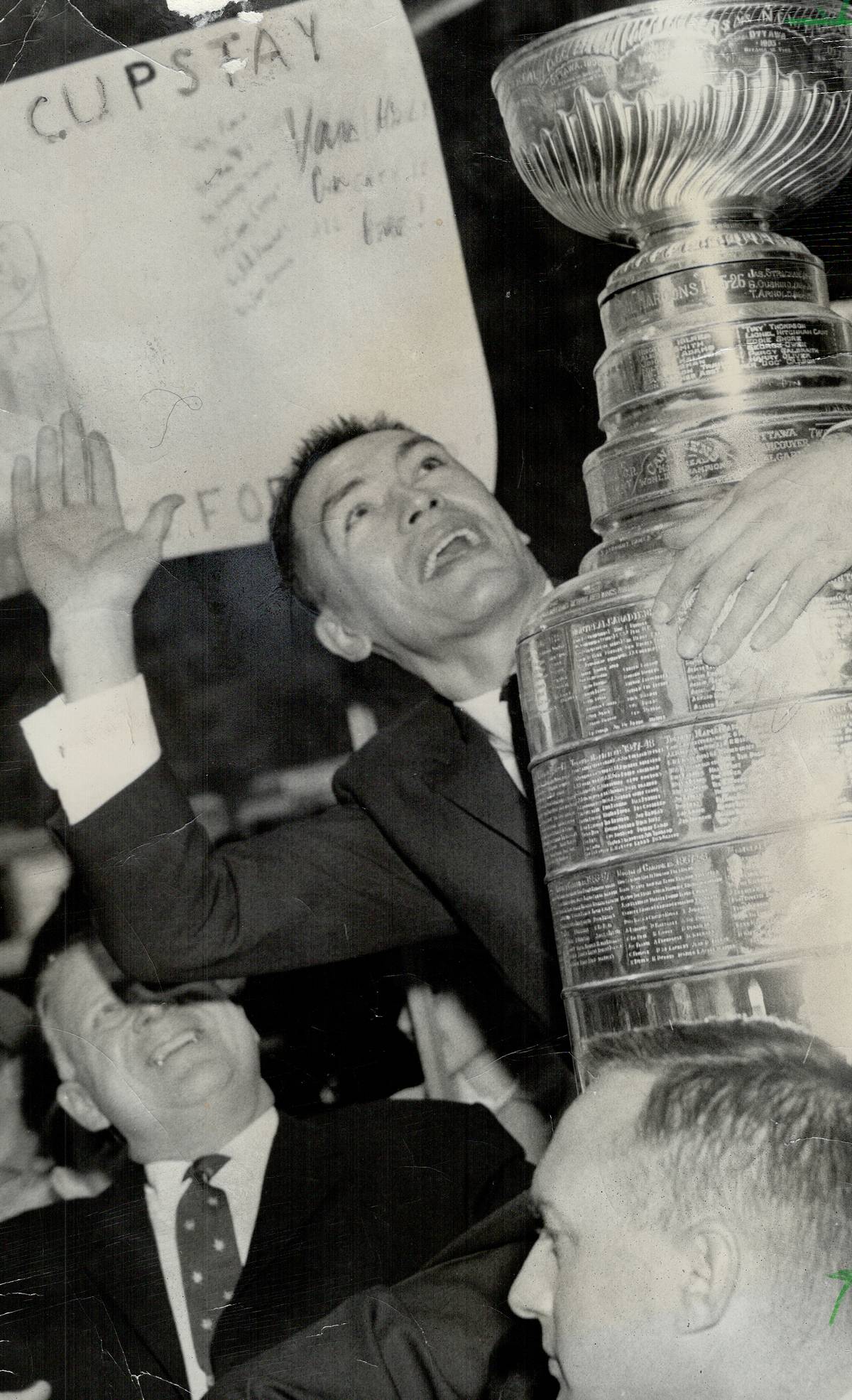 Toronto Maple Leaf team captain George Armstrong holds the Stanley Cup.