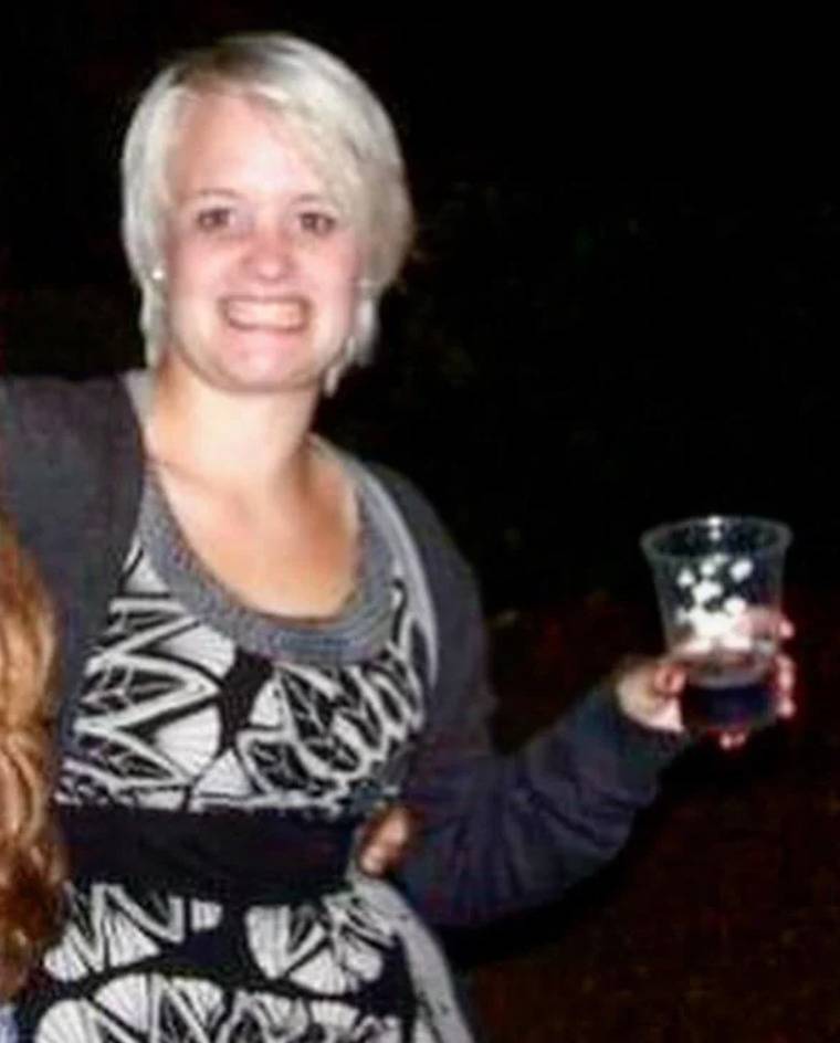 girl with short haircut holding drink looks like she's almost 40