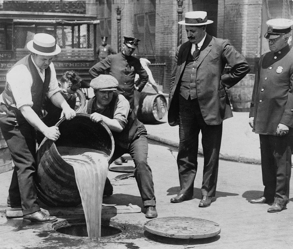 Men pouring out liquor