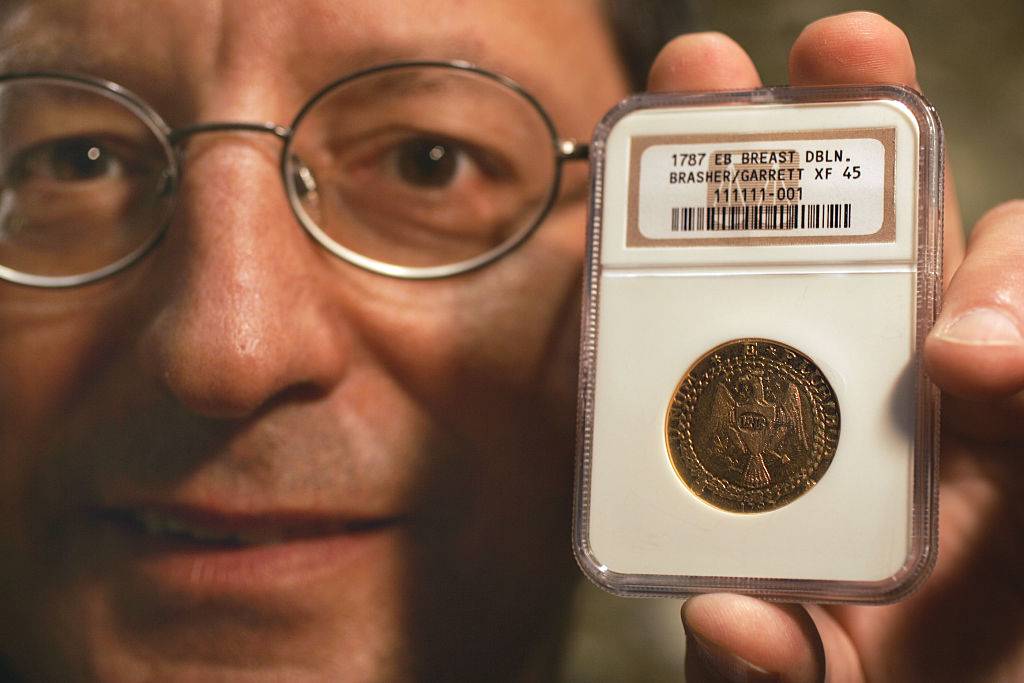 A Laguna man, Steven Contursi, holds the 1787 Brasher Doubloon