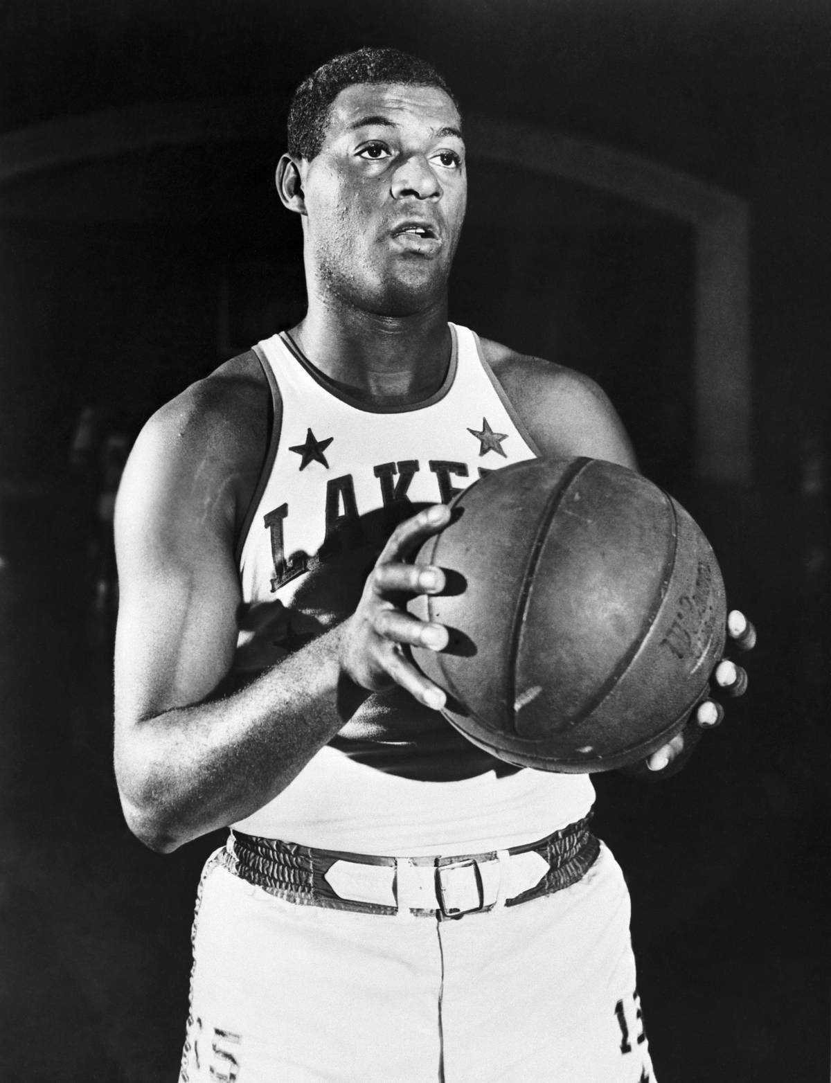 Elgin Baylor Holding Basketball and posing for a picture