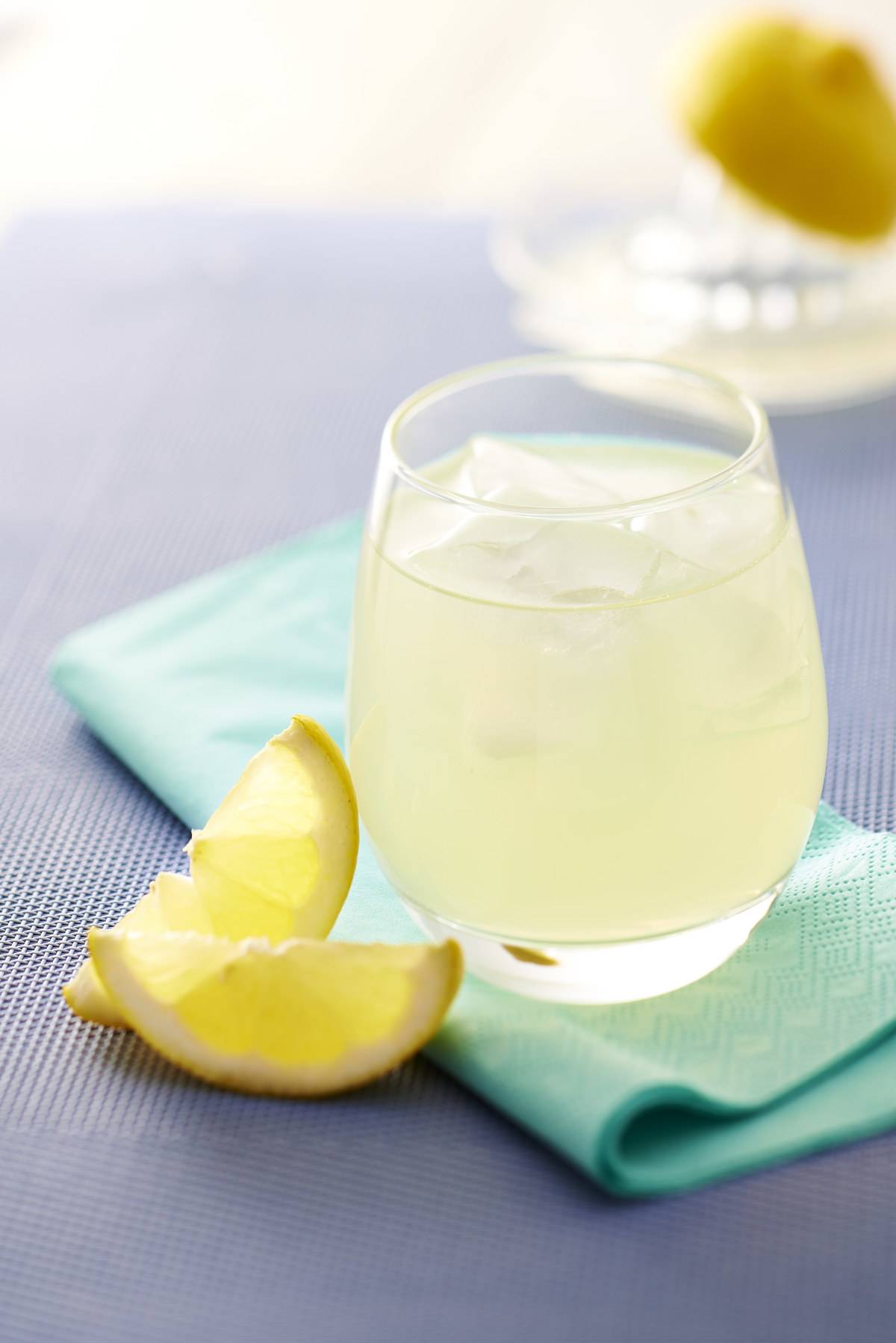 two slices of lemon next to a glass of lemonade