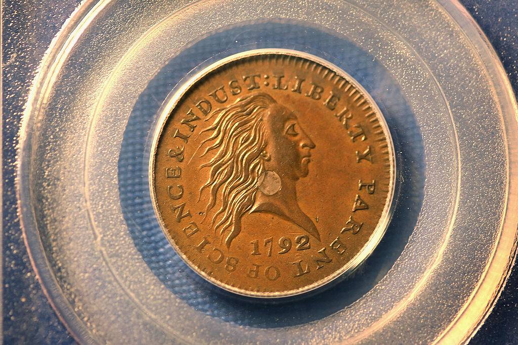 silver center cent from 1792 with front facing side of a person looking to the side