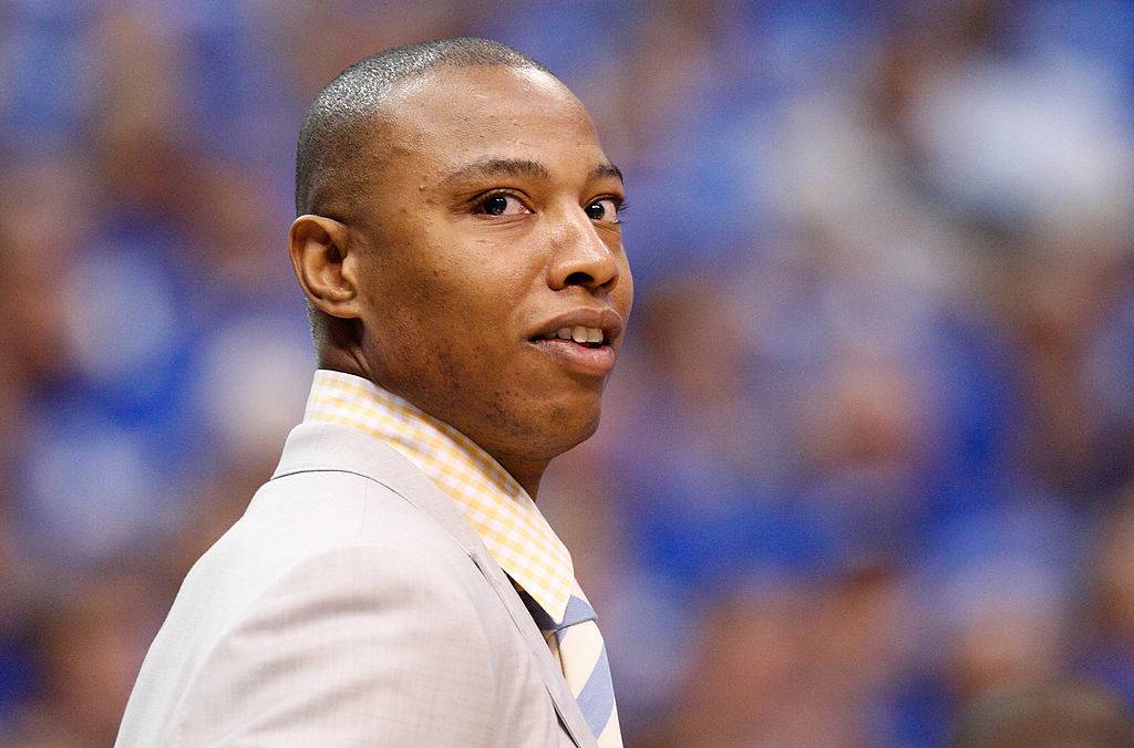 Caron Butler in suit grinning