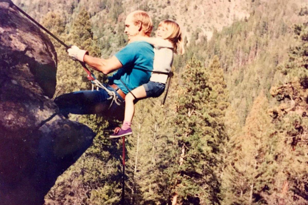 Girl and dad mountain climbing