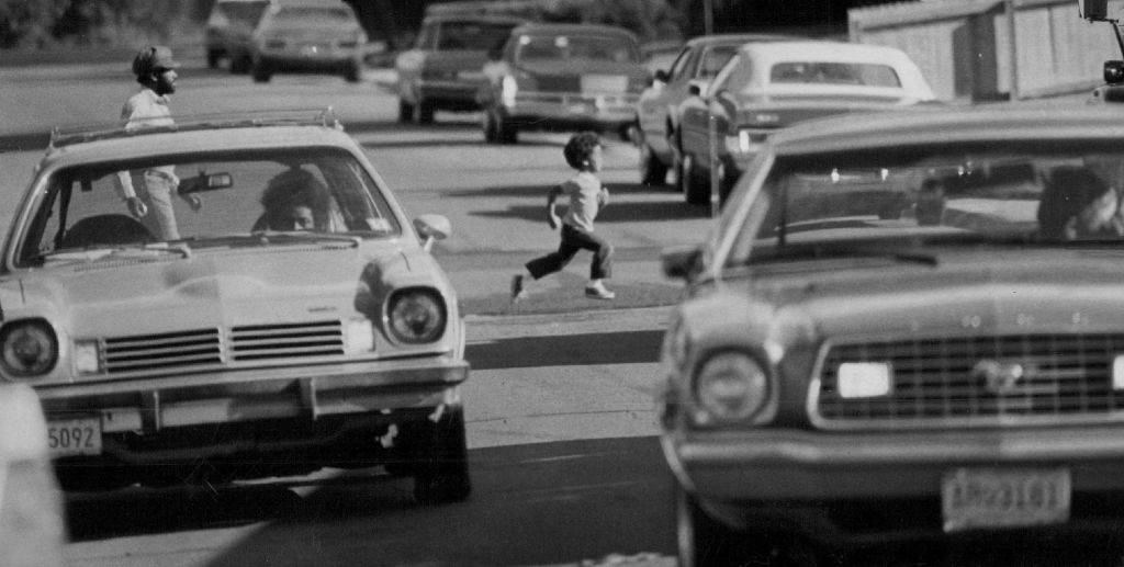 Kid running across the street