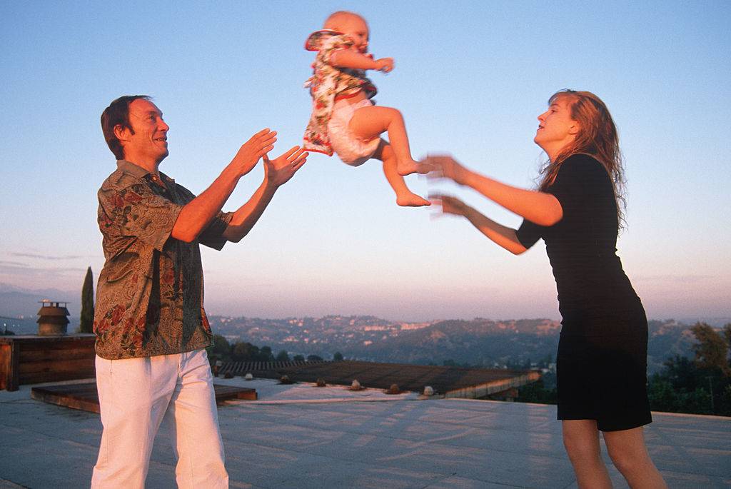 Picture of parents tossing child