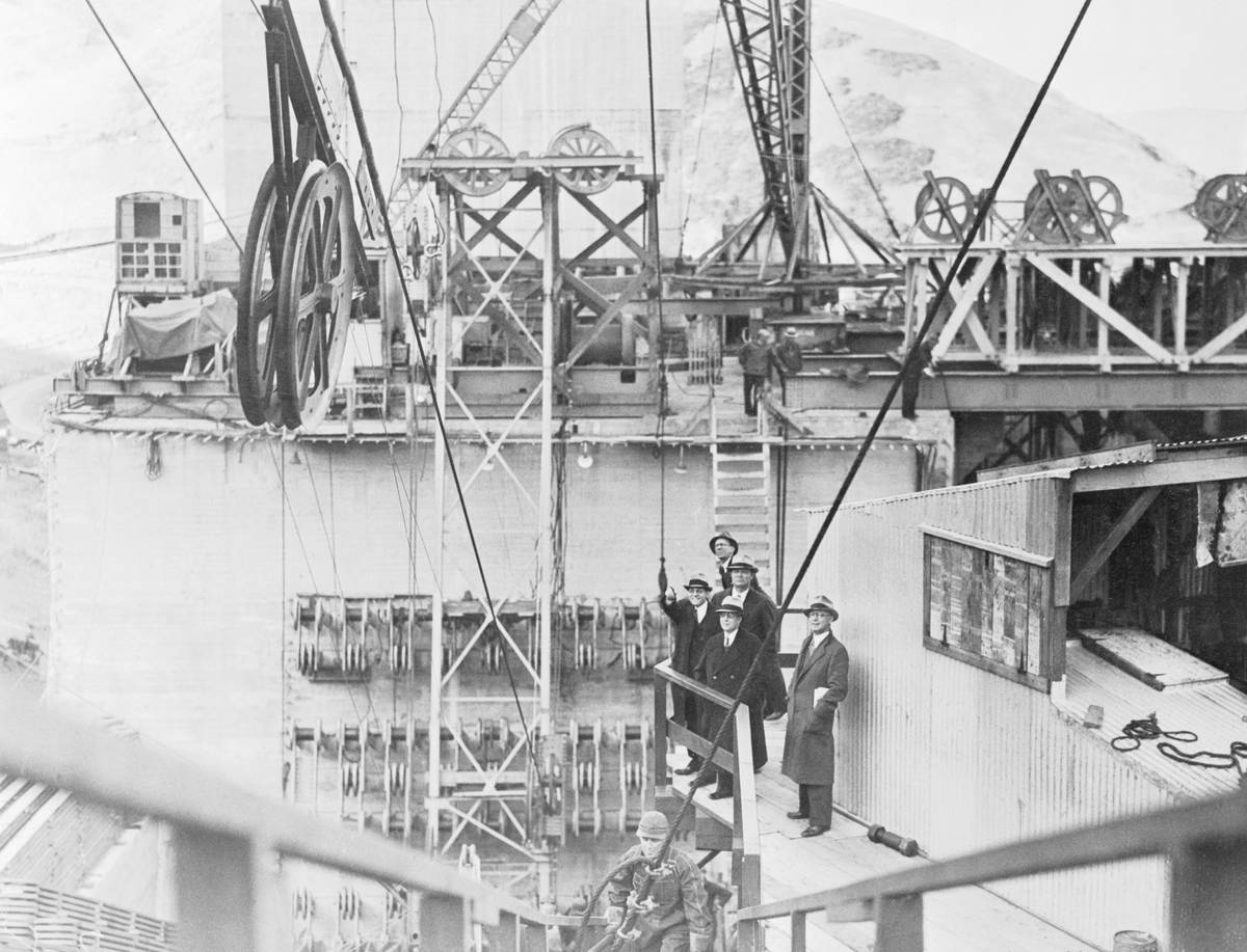 Men Watching Spinning Cable Operation