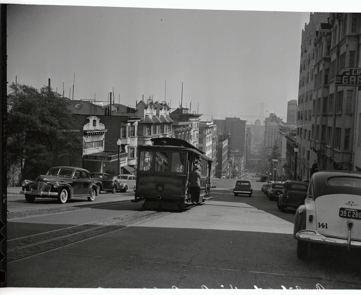 View of Trolley Car and Automobiles on Street