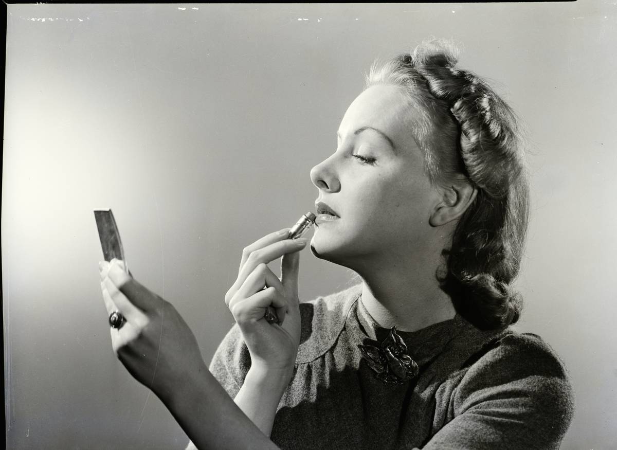 Woman Applying Lipstick