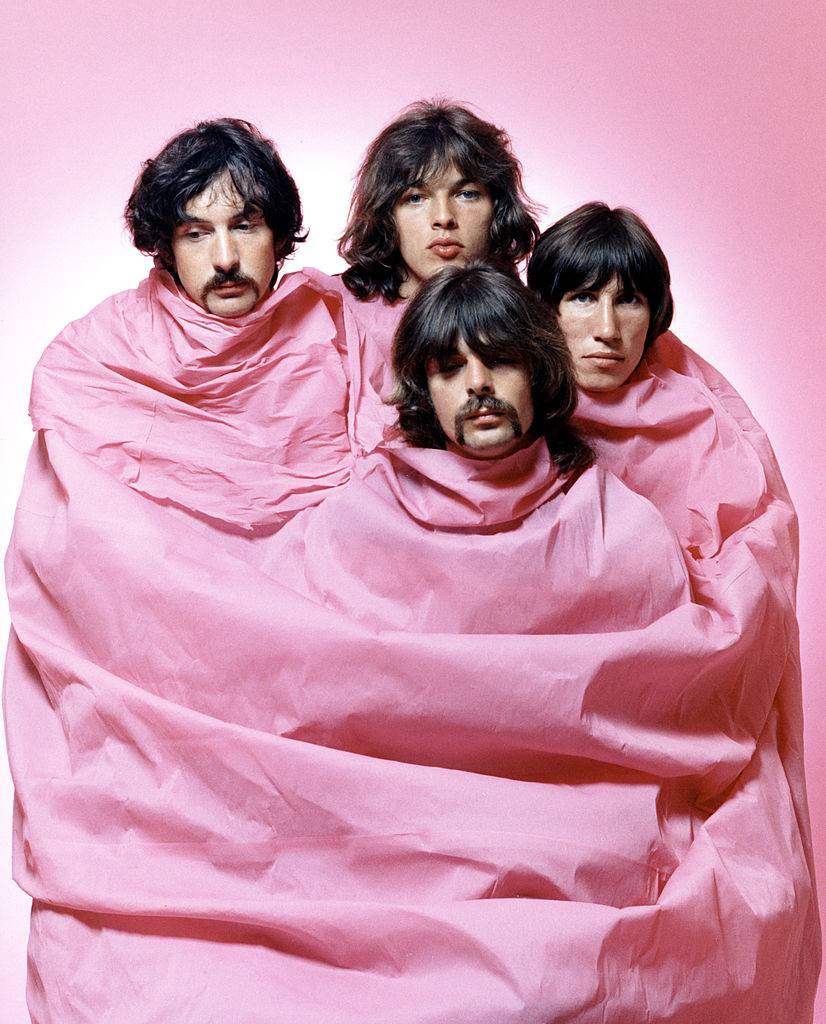 Psychedelic rock group Pink Floyd pose for a portrait shrouded in pink