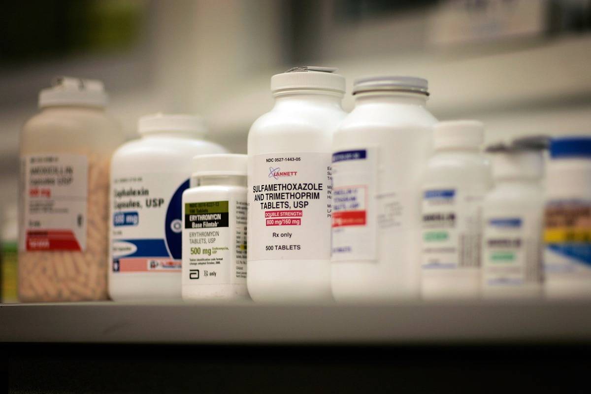 Jars of antibiotics line pharmacy shelves.