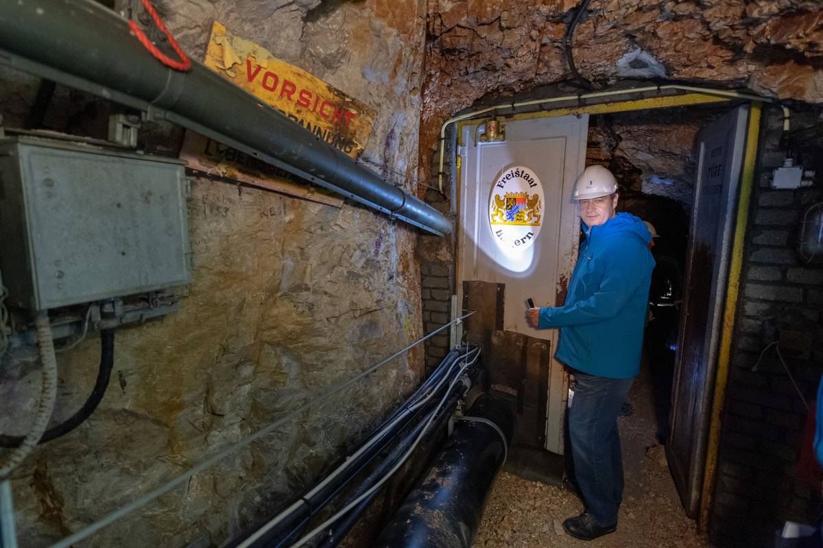 A scientist descends into a tunnel to study permafrost.