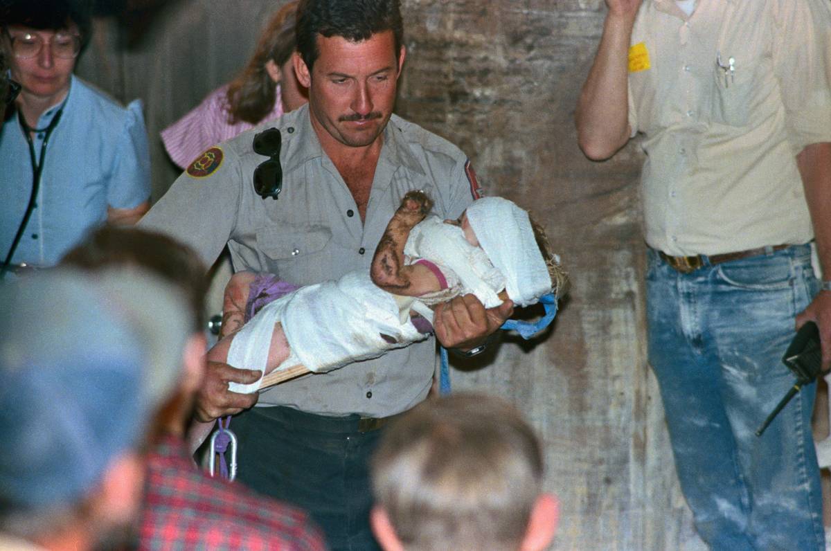 Rescuer Running with Baby Jessica