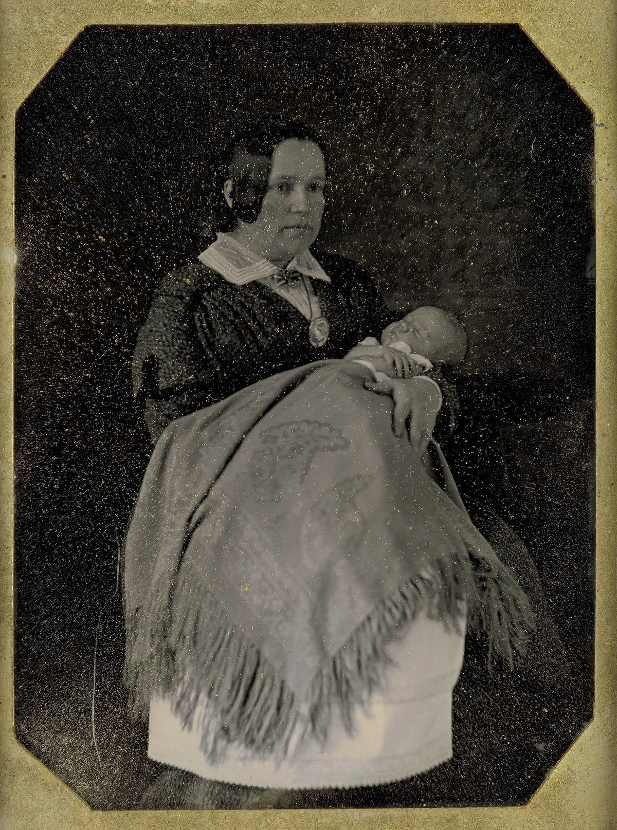 A mother holds her sleeping baby in this 1849 photograph.