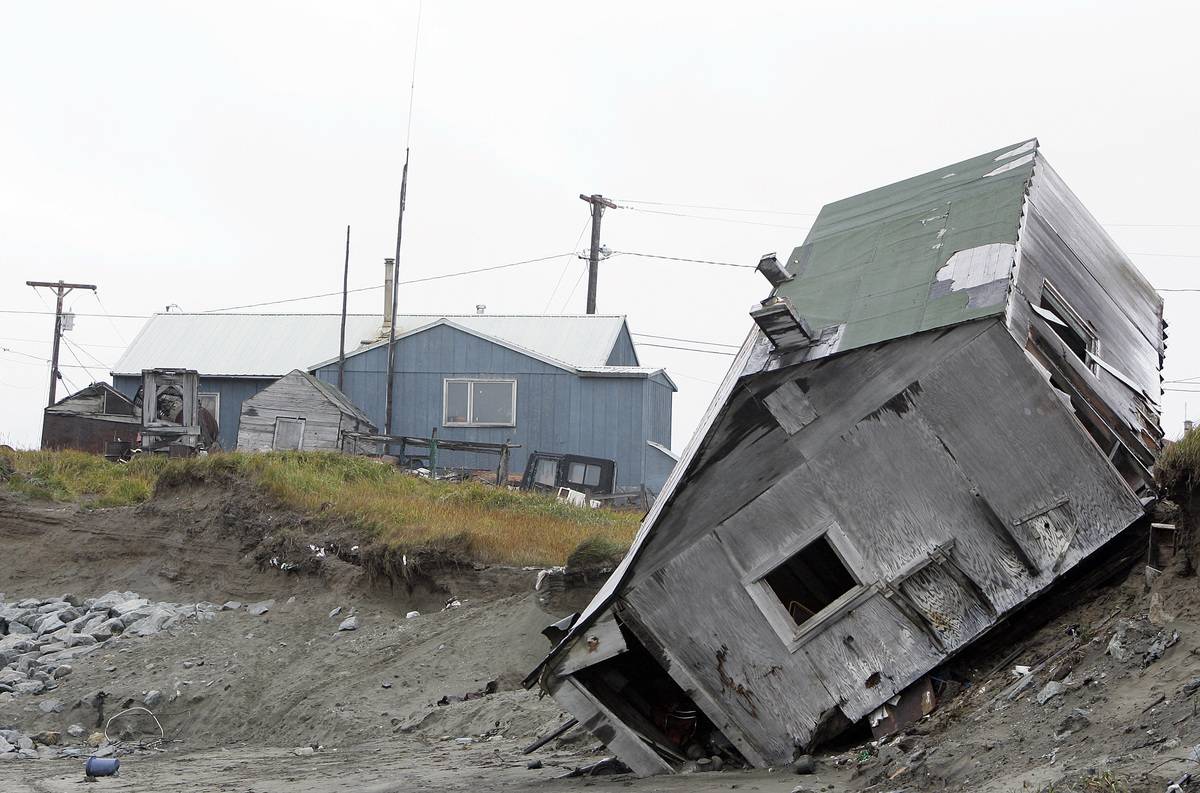 An Alaskan house is toppled over due to erosion from melting permafrost.