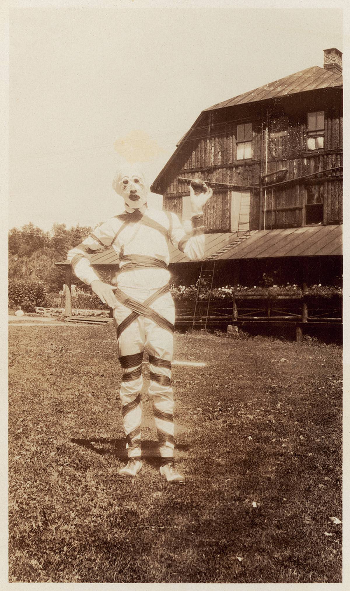 A man dressed in a clown/zombie costume for Halloween in the 1930s