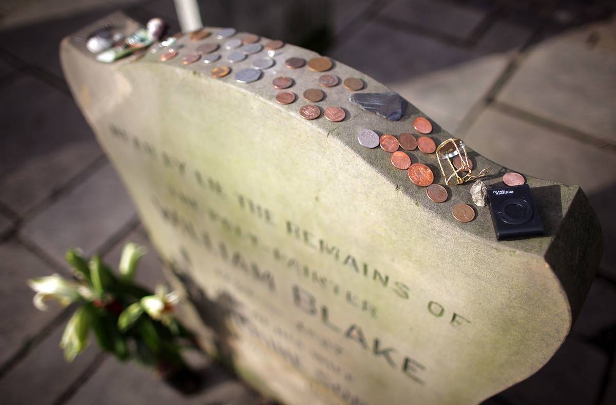 Coins have been placed on a poet's headstone.