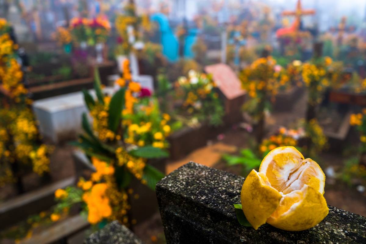 A lemon was placed on top of a headstone in a cemetery during the Day of the Dead.