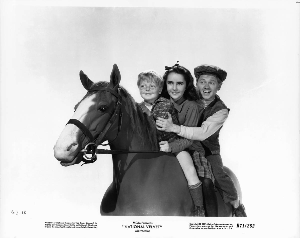 Jackie Jenkins, Elizabeth Taylor, and Mickey Rooney riding horseback in a scene from the film 'National Velvet', 1944.