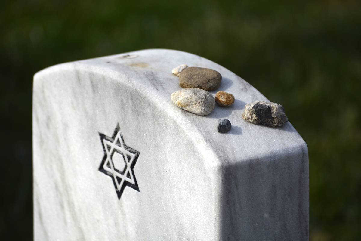 Rockers have been placed on top of a Jewish headstone.