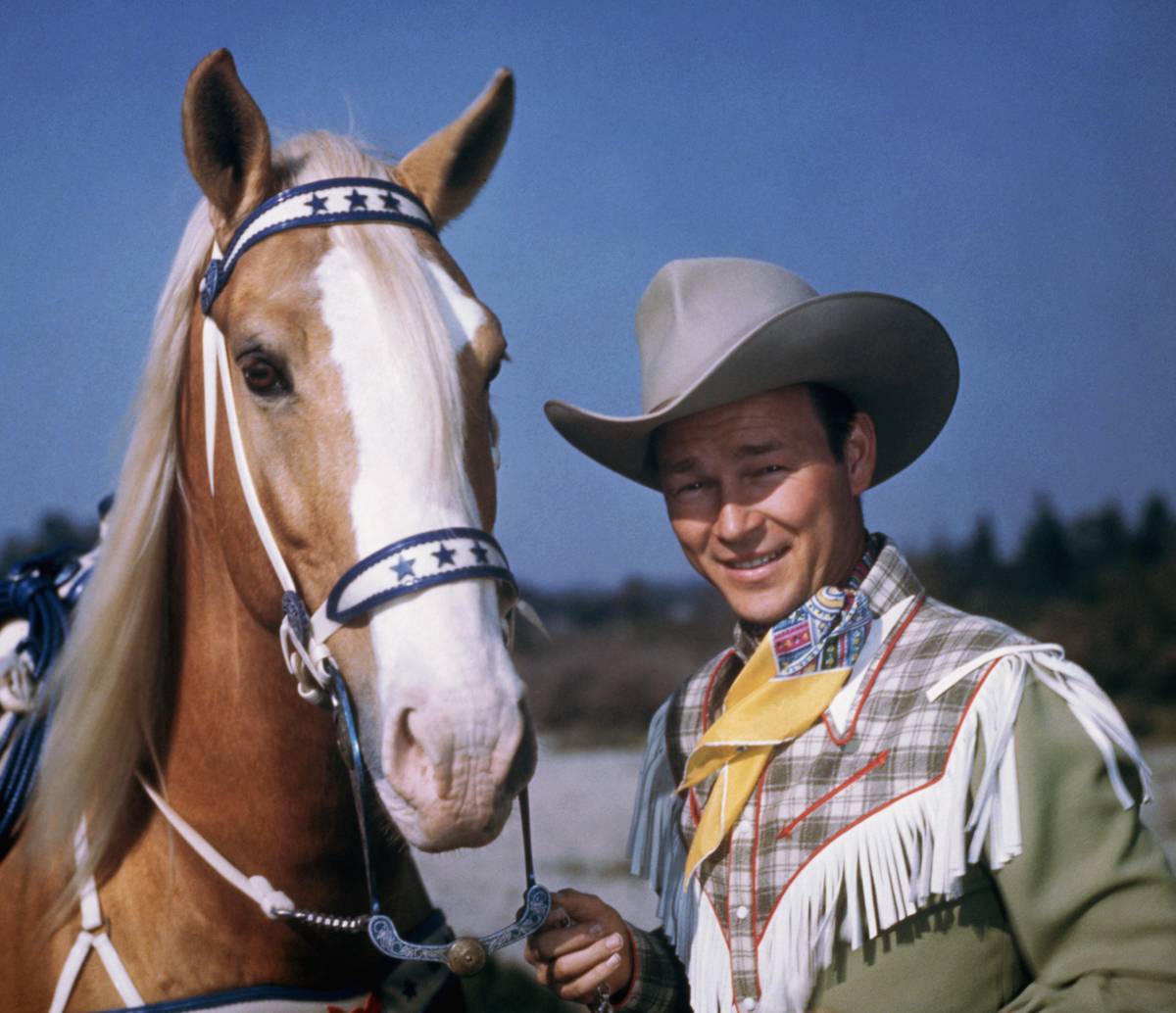 Roy Rogers stands with his horse, Trigger.
