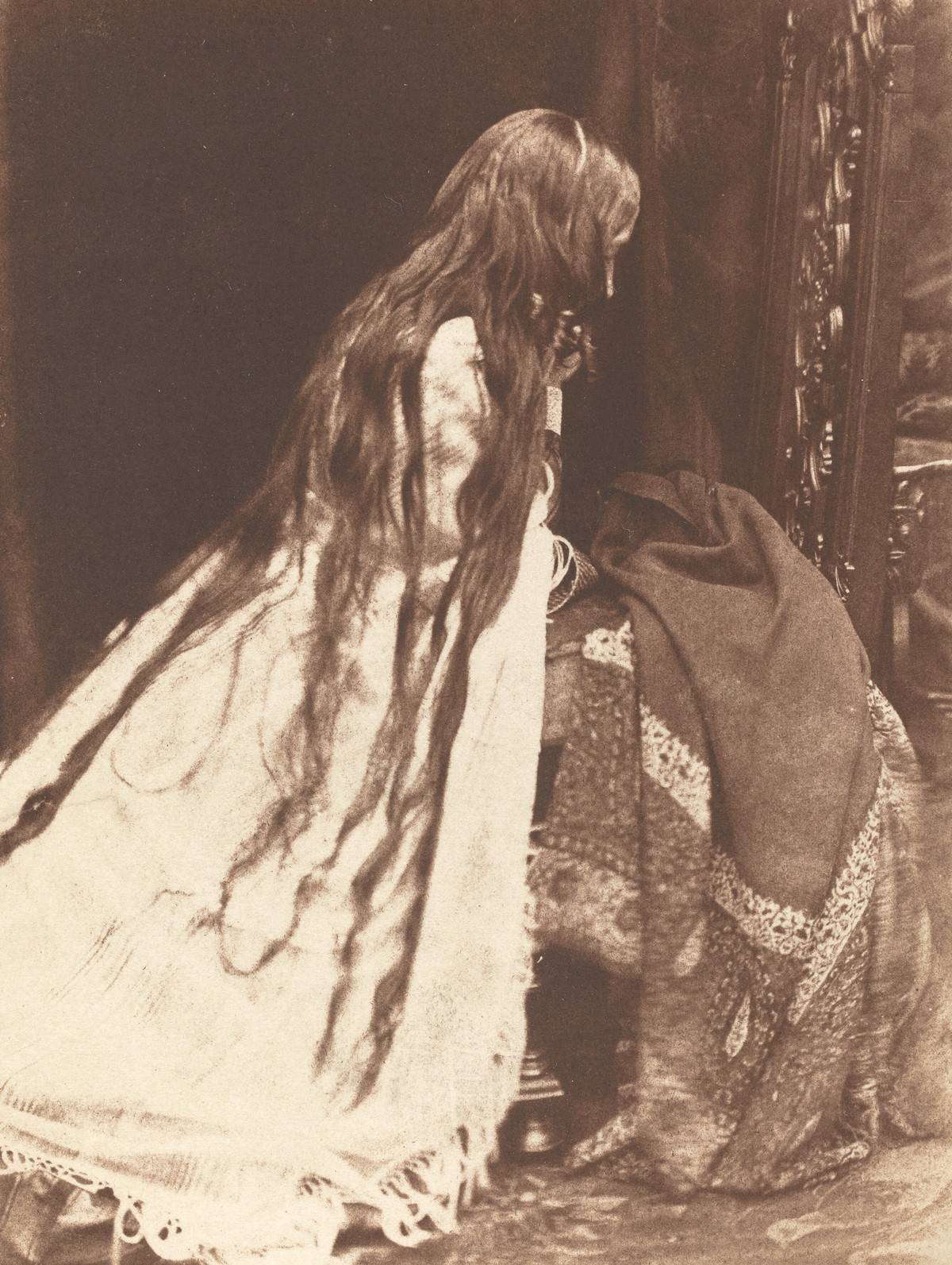 victorian woman with long hair facing away from the camera