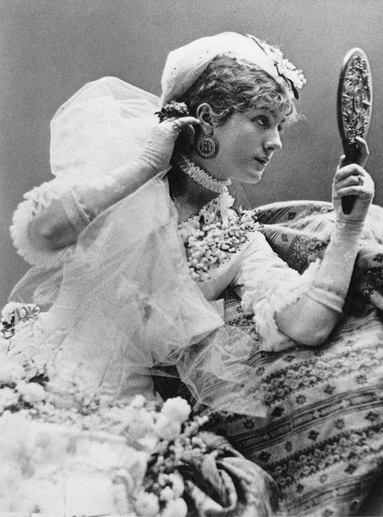 Victorian stage actress looking into a mirror