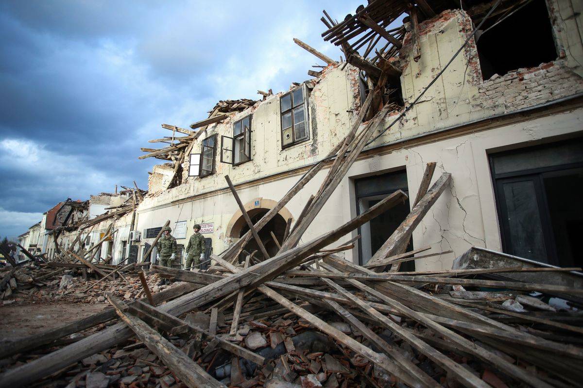 Croatian soldiers walking on debris leftover from the December 2020 earthquake.