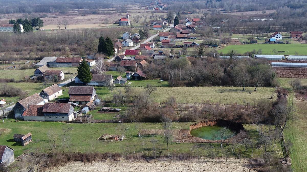 Aerial photo of the village of Mecencani which has become pockmarked with numerous sinkholes following a 6.4 magnitude earthquake.