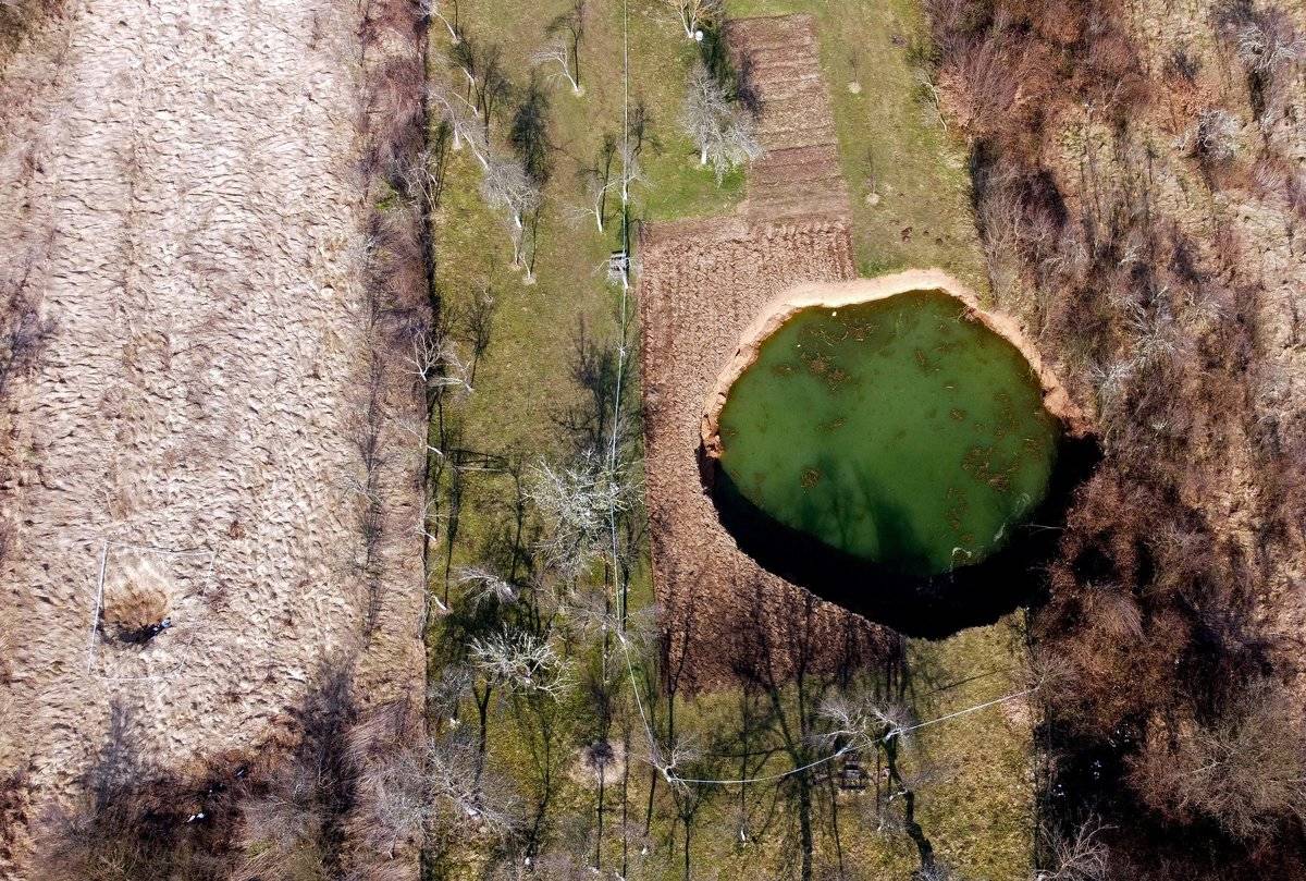 Aerial photo of one of the sinkholes in Croatia filled with water.