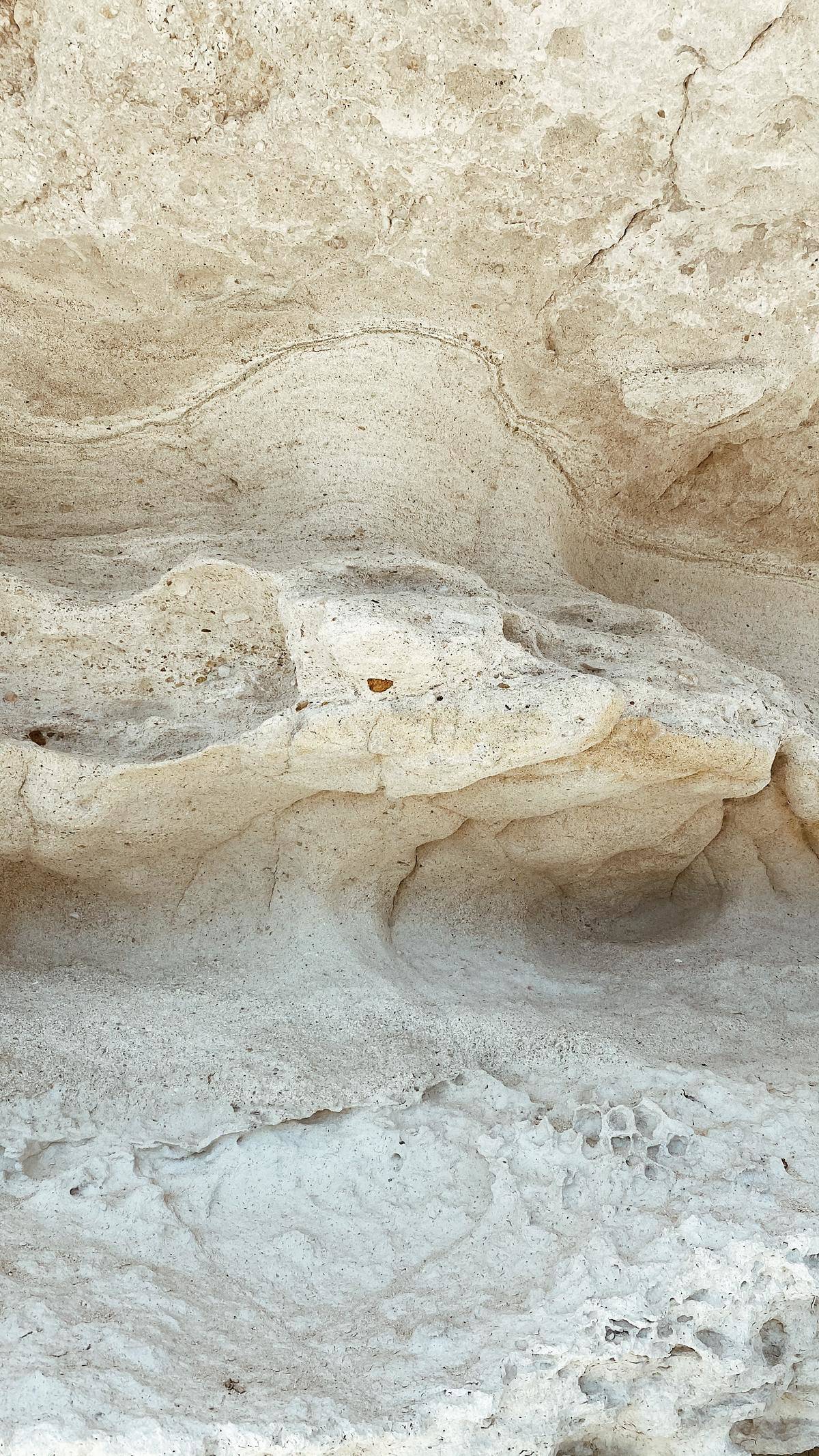 A cave made of off-white limestone rock.