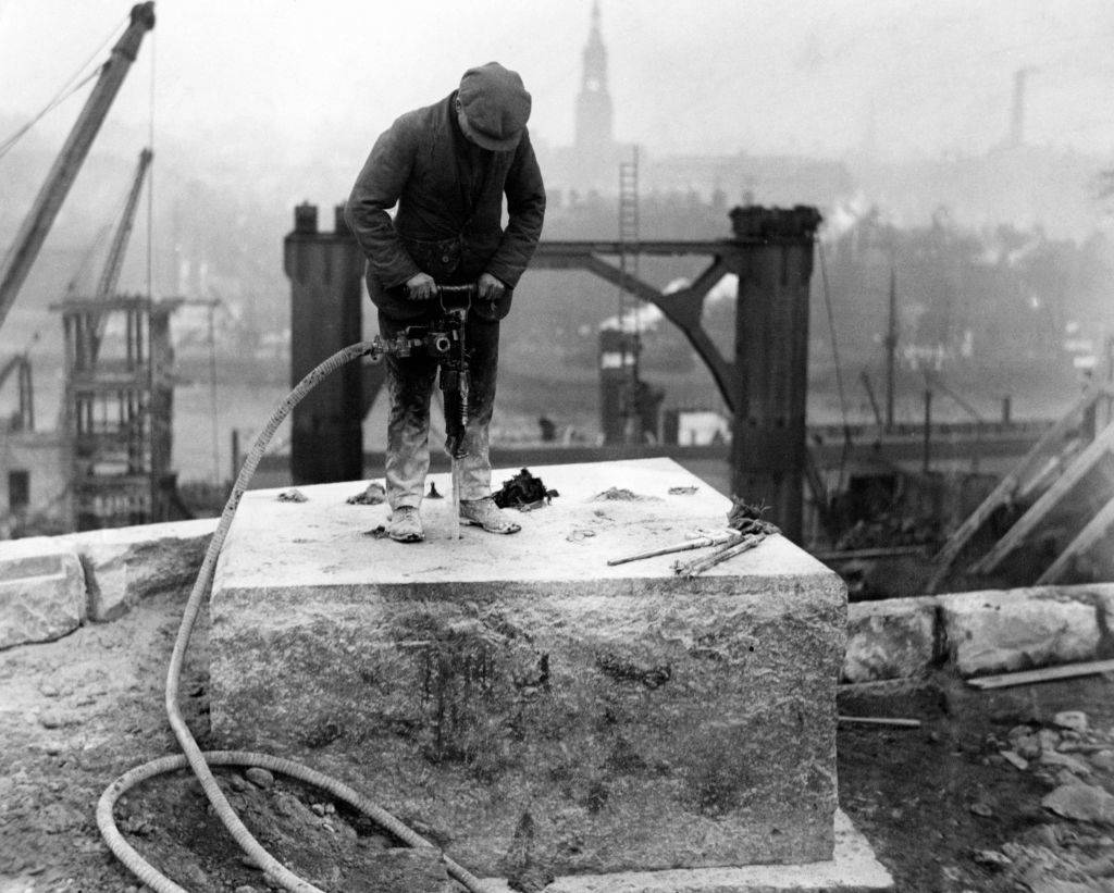 A workman drilling holes