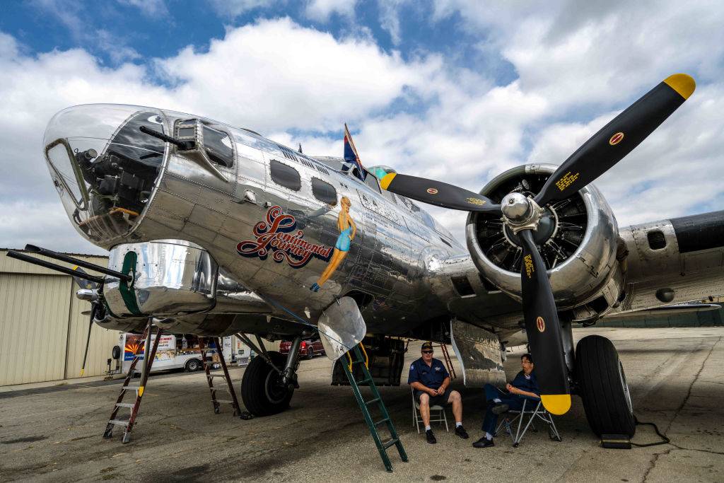 Crews take a break underneath a World War II B-17 bomber