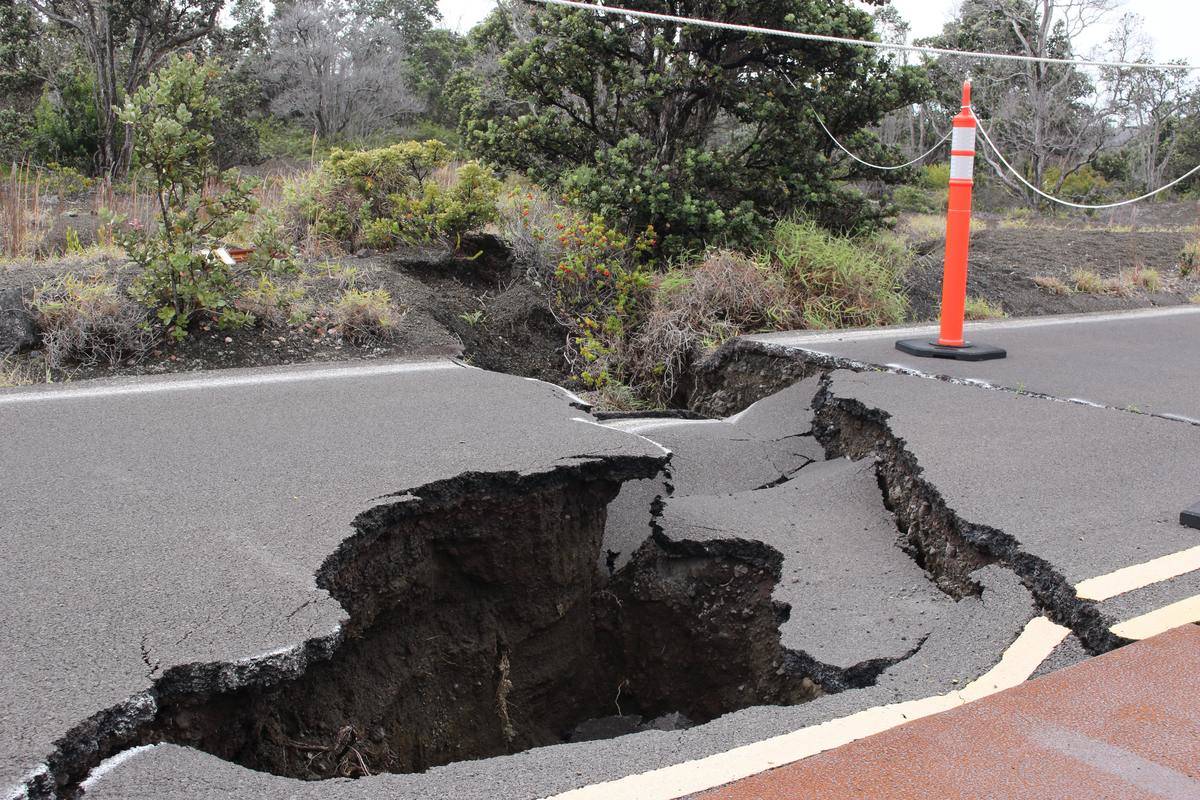 crack sinkhole in road with pylon