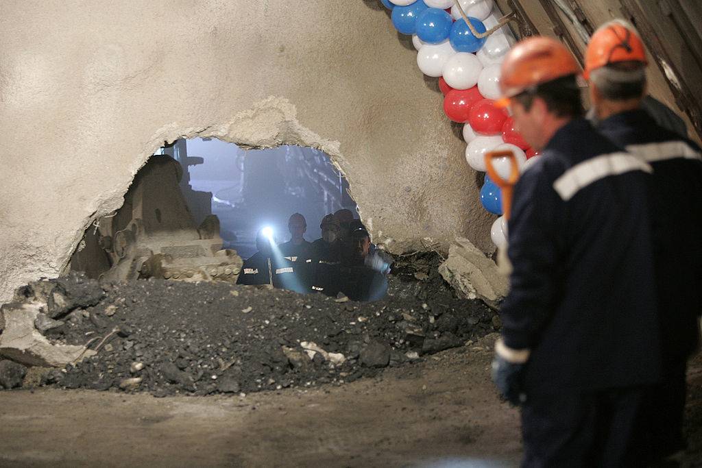 Workers drill a hole