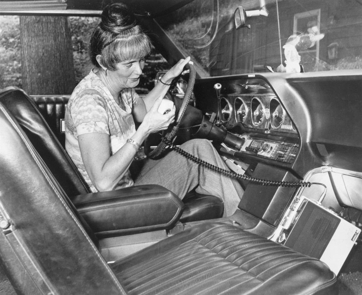 Woman Using CB Radio in Her Car